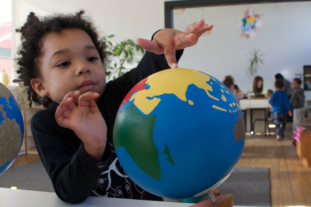 Stock photo of a boy with a globe